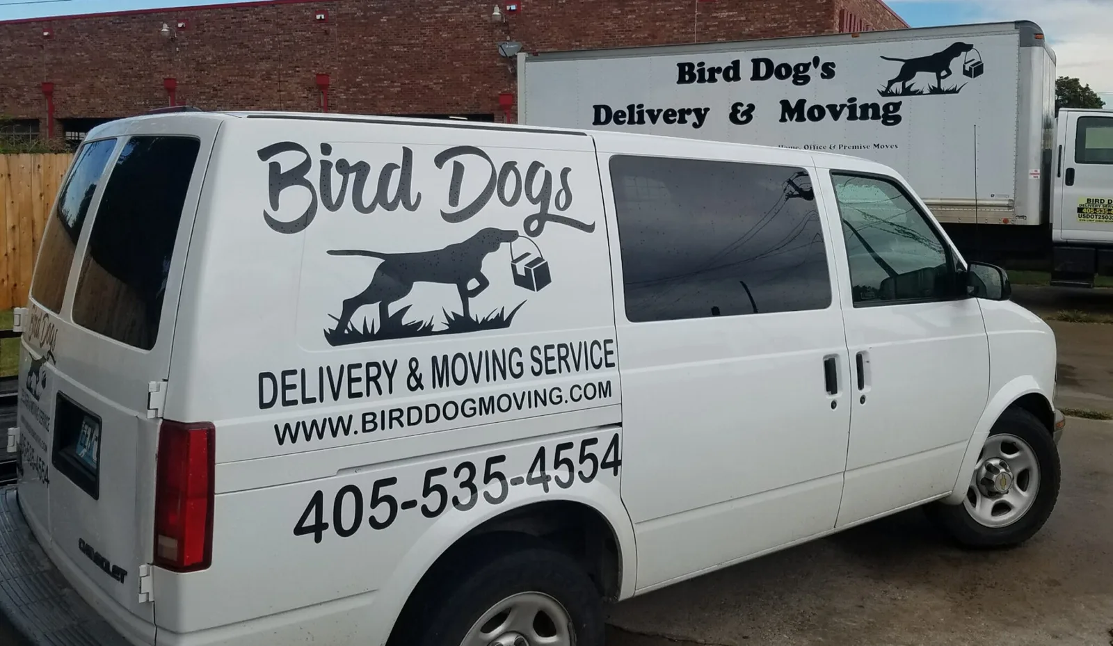 Bird Dog moving van and box trucks parked together in Oklahoma City
