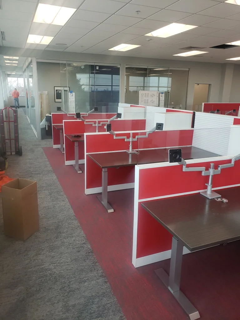 Red office workstations arranged in their completed layout