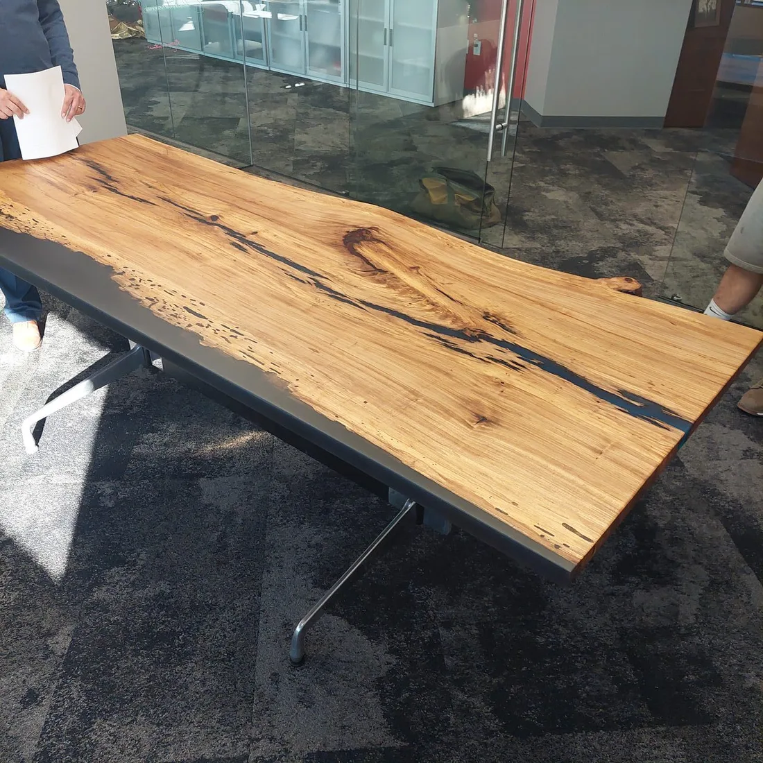 Oversized live-edge conference table inside an office